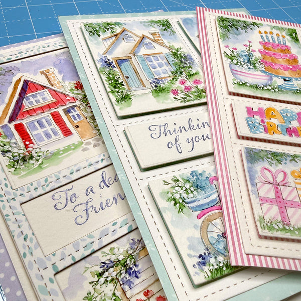 Collection of colorful greeting cards with various designs on a blue grid background.