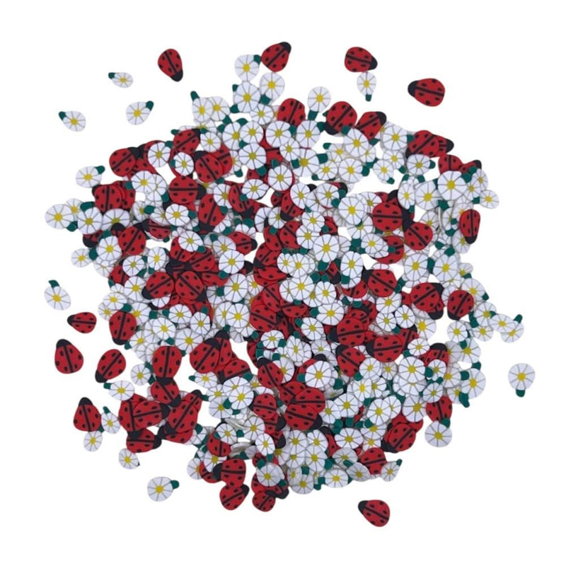 Pile of ladybug and flower-shaped candies on a white background