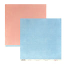 Two square sheets of textured paper, one in dusty pink and one in light sky blue, overlapping on a white background. A small paper label is visible along the bottom edge of the blue sheet.
