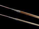 Two paintbrushes with wooden handles on a black background