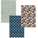 Three rectangular fabric or paper pattern swatches overlapping on a white background: a green and white trellis design, a navy and white damask design, and a burgundy floral print with cream flowers.