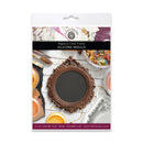 A package of a crafting silicone mould from DMC Studio, featuring an ornate bronze-colored frame design. The packaging displays a flat-lay of the mold with various craft supplies on a white wood background.