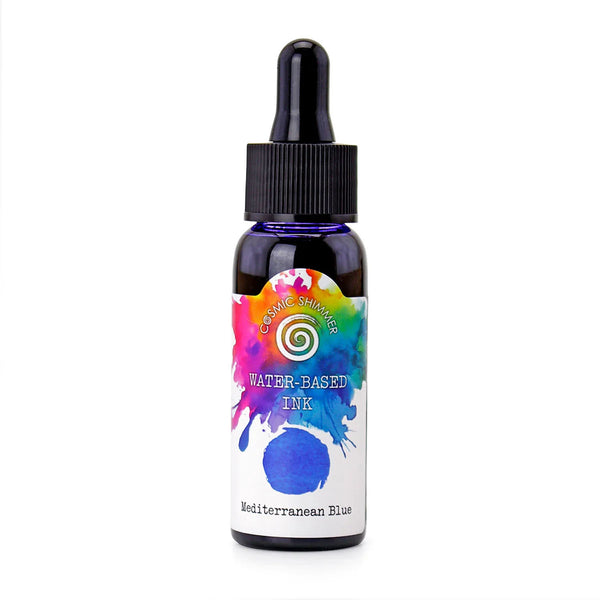 A small dark glass dropper bottle of Classic Designs Water-Based Ink in the shade Mediterranean Blue, featuring a colorful watercolor splash label on a white background.