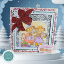 A handmade Christmas greeting card displayed on a white pedestal. The card features a large red glitter bow, a scalloped white and red border, and a central illustration of two cartoon cats wearing winter clothing, with a pink 'Christmas Wishes' tag.