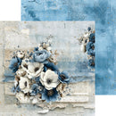A decorative scrapbook paper or art print design featuring blue and white flowers over a distressed beige background with faint text and textured paper effects. A second blue patterned sheet is partially visible behind it.