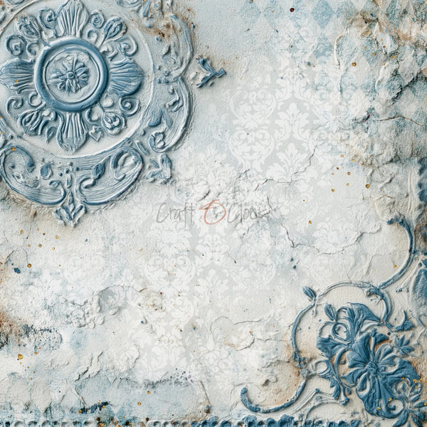 A distressed scrapbook paper or textured backdrop design featuring a vintage ornate medallion in the top-left corner, a floral relief detail in the bottom-right, and a faded damask pattern over a weathered off-white and light blue surface.