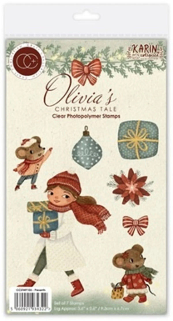 Karin's 'Olivia's Christmas Tale' clear photopolymer stamp set in its original retail packaging, featuring festive illustrations of a girl, mice, bows, and gifts.