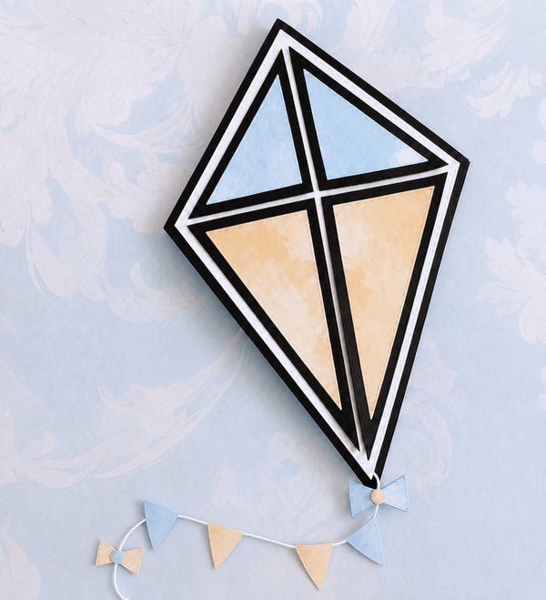 Geometric kite with black frame and pastel colors on a light blue background