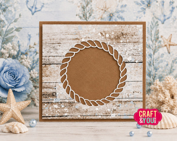 Decorative card with rope design on a wooden background with flowers and shells.