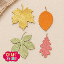 Four autumn-colored paper leaf cutouts in yellow, orange, green, and pink arranged on a beige textured background, with a pink Craft & You Design logo in the lower left corner.