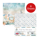 A craft paper set package labeled 'Fun by the sea' with a red circle reading '6 Sheets.' The package shows two sample paper designs: a pastel illustrated sheet with a small character and ocean scene, and a white sheet with a light blue anchor pattern.