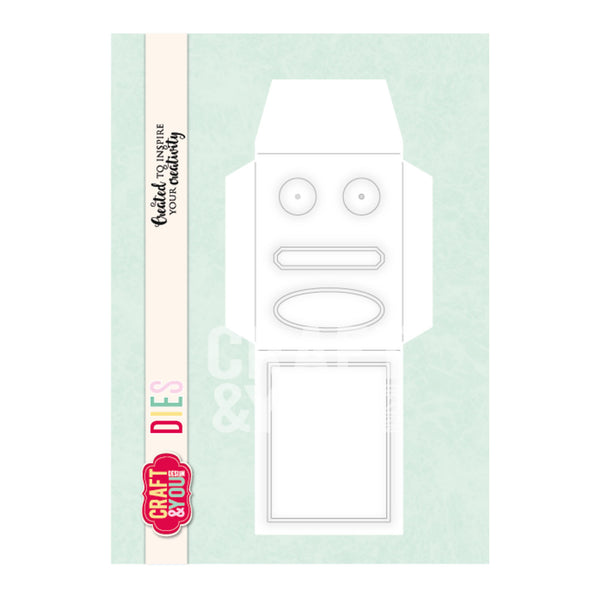 A package of Craft & One die-cuting dies, featuring a white cardboard template with facial features and a blank rectangular section on a pale mint green background. A vertical cream banner on the left displays the text 'Crafted to Inspire your creativity', 'DIE CUTTING DIES', and the red Craft & One logo.