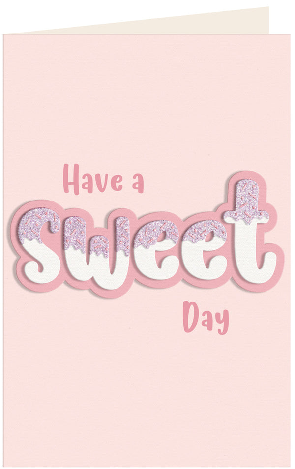 A pink greeting card with the words 'Have a Sweet Day' in stylized lettering. The word 'Sweet' is large and white with pink outlines, and the letters have a light purple glitter-like texture on top.
