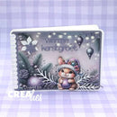 A square greeting card featuring a festive Christmas design with a small bunny wearing a purple hat and holding a purple ornament, surrounded by snowflakes, pine branches, ornaments, and the text 'wennne kerstgroet'. The card is photographed against a lavender-and-white checkered background.