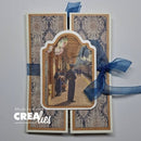 A handmade greeting card or art print featuring a vintage station platform scene in the center, surrounded by ornate damask-patterned panels and tied with a sheer blue ribbon. A watermark reading 'Made by CreaLies' is visible in the lower left corner.