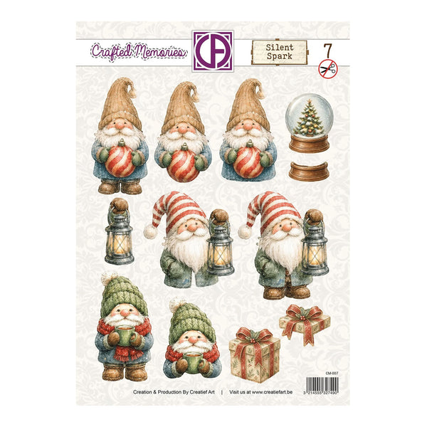 A sheet of decorative craft stickers or decals featuring illustrated Christmas gnomes, lanterns, a snow globe with a tree, and wrapped gifts. The sheet has a cream background with a subtle damask pattern and printed branding at the top reading 'Crafted Memories' and 'Silent Spark'.