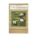 A booklet  titled 'Creating with Magic Scapes Clear Composition' shown upright against a plain white background. The package features a tan and beige striped border, a green central collage panel with photos and scrapbook elements, and smaller text near the bottom.