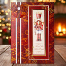 A Christmas-themed greeting card featuring a nutcracker illustration and the text 'All is Calm All is Bright,' styled on a wooden surface with a warm, blurred holiday background.