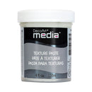 A white plastic jar of DecoArt Media Texture Paste with a black and gray label, shown on a plain white background.