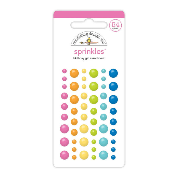 A package of Doublebug Design Co. 'sprinkles' birthday girl assortment stickers, featuring rows of colorful bubble stickers in pink, orange, yellow, green, and blue on a white backing card with a pink header.