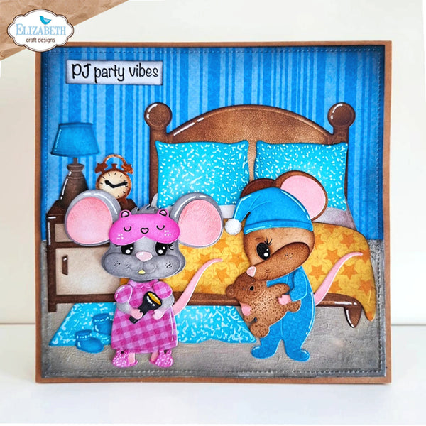A square handmade greeting card featuring a whimsical mouse family in pajamas in front of a bed. The card has a blue striped background, a wooden headboard, and a gray base.