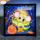 A handmade Halloween card featuring a cute green dragon mouse character holding a pumpkin bucket, next to a carved orange pumpkin and a broom, with the text 'A LITTLE DRAGON MAGIC!' on a dark blue patterned background.