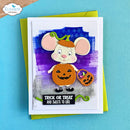 A handmade Halloween greeting card featuring a cute cartoon mouse dressed as a pumpkin, holding a small bucket of treats. The card is layered over a bright yellow-green envelope and set against a solid turquoise-blue background.