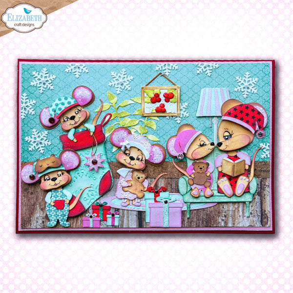 A square craft card or scrapbook design featuring six cartoon mice in winter clothing gathered around a table with gifts, a framed apple print, and snowflake decorations on a turquoise patterned background. The card is presented on a light pink patterned backdrop with an 'Elizabeth craft designs' logo in the top-left corner.