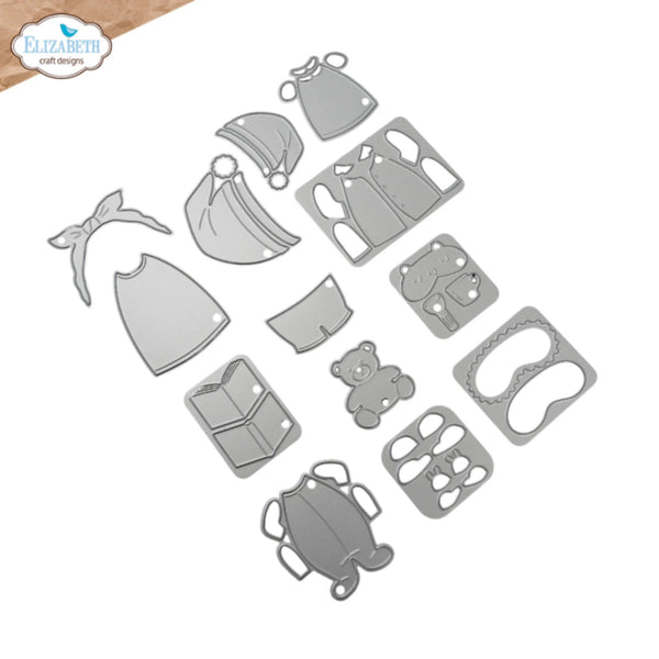 A set of silver metal die-cut craft pieces shaped like baby clothing and accessories, including a hat, bib, pouch, boot, teddy bear, and other small cutouts, arranged on a white background. The Elizabeth craft designs logo is visible in the top-left corner.