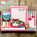 A handmade pop-up card featuring a sleeping tabby and white cat with a red bow, surrounded by pop-up elements including a fishbowl, cat food bowl, and hearts. The card has pink and white stripes and the text 'Life is BETTER with a CAT'.