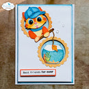 A handmade greeting card featuring a cartoon orange cat wearing a blue fisherman hat and holding a fishing rod over a fishbowl illustration. The card has a blue border, a white center, a small message tab reading 'Best friends fur-ever', and is photographed on a textured brown surface.