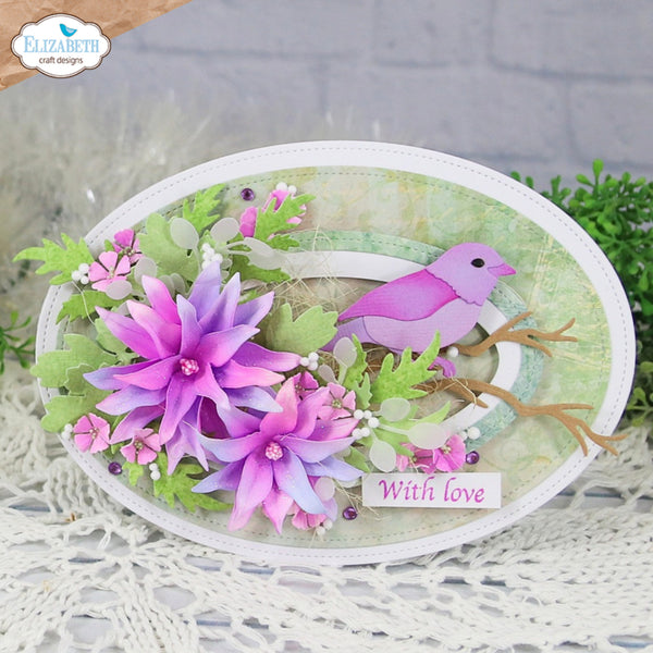 An oval handmade paper craft plaque featuring a purple bird, pink and purple flowers, green leaves, and a small card that reads 'With love'.
