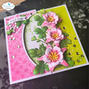 A handmade square greeting card with layered pink and white flowers, green leaves, pink patterned paper, and a bright yellow-green background, photographed on a dark reflective surface. The top-left corner shows the brand mark 'Elizabeth craft designs'.