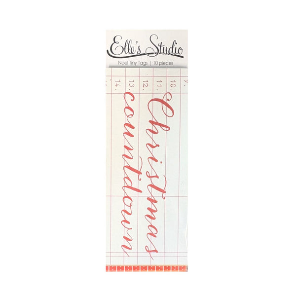 A package of 10 Noel Tiny Tags from Elle's Studio, featuring red cursive script tags printed on a white grid background.