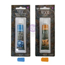 Two tubes of Dicotomy brand Metallic Wax Gel Wax in a matte finish and amber tinted finish, packaged in clear plastic blister packs with a textured dark background. Blue and orange color swatches are shown below the packages.