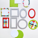 A flat-lay arrangement of scrapbooking paper and metal dies on a white background. The set includes various rectangular and oval paper frames with scalloped edges in red, green, silver, and multicolor patterns, alongside solid green and white paper circles.