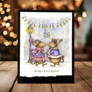 A handmade greeting card featuring a watercolor illustration of two mice dancing under holiday lights, displayed on a wooden surface with a warm, blurred bokeh background.