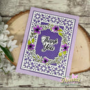 A handmade greeting card with a lavender border, white perforated floral frame, and purple center reading 'Thank You,' styled on a wood slice with white flowers. A 'Donna' watermark appears at the bottom right.