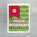 A handmade Christmas greeting card featuring a green patterned background with pine tree motifs, a bright pink banner with a teddy bear illustration, and white lettering that reads 'MERRY CHRISTMAS'.
