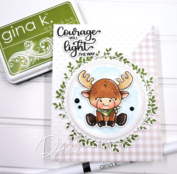 Card with a moose illustration and 'Courage will light the way' text, featuring Gina K. Designs products.