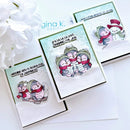 Three handmade holiday greeting cards with penguin illustrations, arranged on a white surface with white flowers in the corner. The cards feature layered white and mint green backgrounds, black borders, and text including 'Wishing you a sleigh full of happiness' and 'Fa la la la love sharing the joy'.