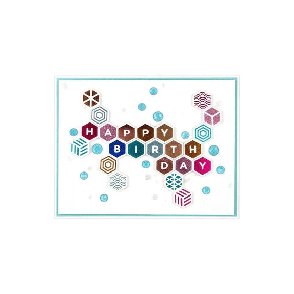 A square greeting card featuring a colorful geometric 'HAPPY BIRTHDAY' design with hexagonal letter tiles and scattered patterned dots on a white background.
