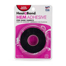 Heat'n Bond HEM ADHESIVE tape roll in a clear plastic spool with black tape, packaged on a white and pink backing card with 'SUPER WEIGHT' and 'FOR DARK FABRICS' text.