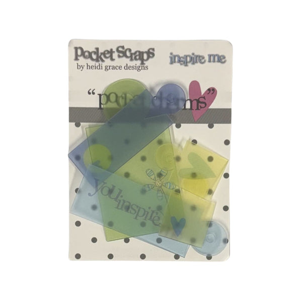Pocket Scaps 'inspire me' scrapbook paper pack by Heidi Grace Designs, featuring translucent green, blue, and yellow paper pieces with hearts and text on a white backing card with black polka dots.