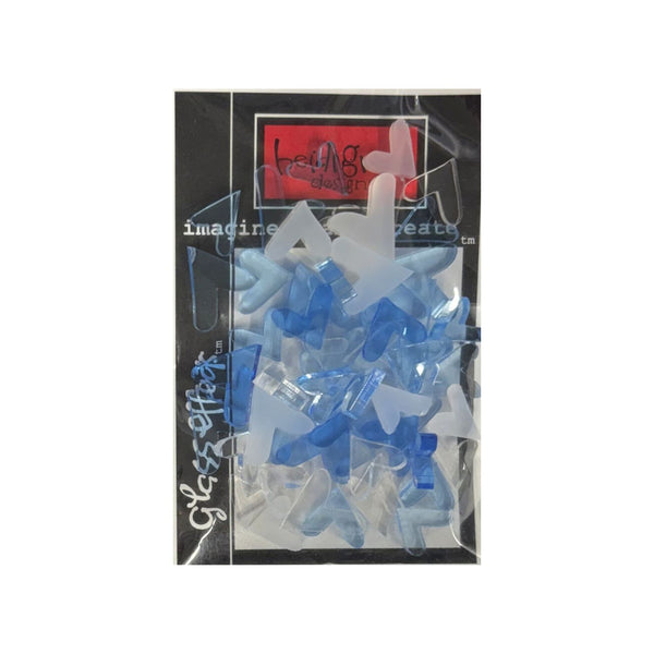 A package of translucent blue and white plastic heart-piece-shaped accessories inside a clear plastic bag with a black backing card. The card features a red logo at the top and white stylized text.