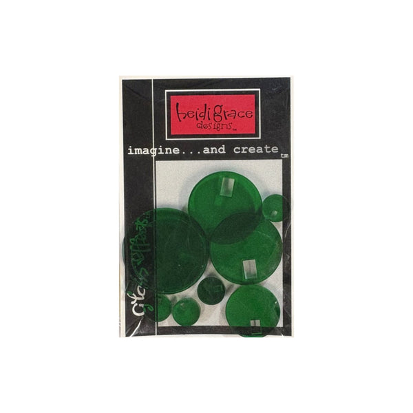 A package of green circular craft embellishments  by Heidi Grace Studios, shown in its black and white retail packaging with a red logo label.