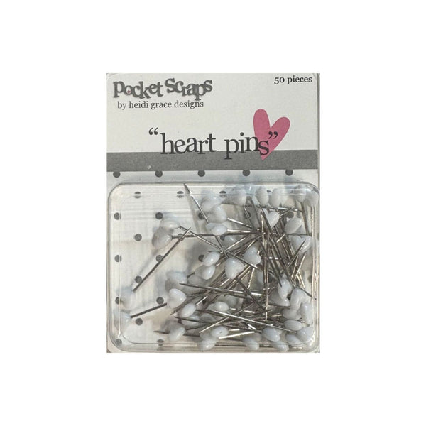 Pack of 50 heart-shaped craft pins in a clear plastic clamshell package with a white paper header card. The header card features the brand name 'Pocket Scaps by heidi grace designs' and a pink heart graphic.