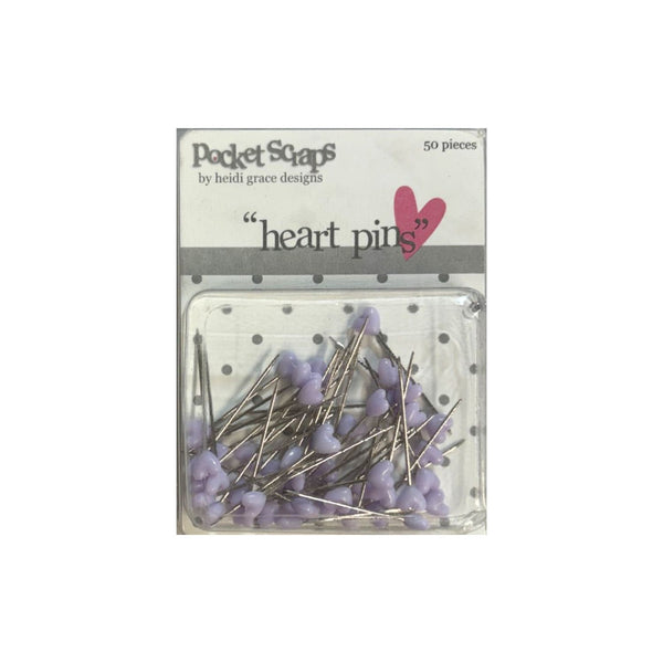 Pack of 50 heart-shaped pinback buttons in light purple, packaged in a clear plastic bag with a white paper header card labeled 'Pocket Scaps by beth grace designs'.