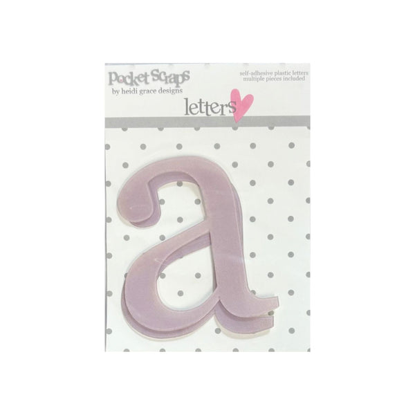 A lavender plastic letter 'a' from the Pocket Scrapbook Letters set by Heidi Grace Designs, shown on its retail backing card against a white background.