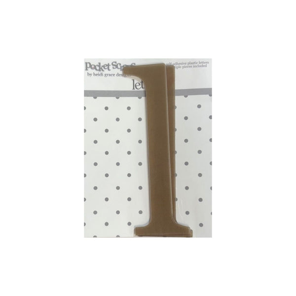 A brown plastic letter 'I'  from Pocket Songs by Beth Grace Design, shown on its white and gray polka dot backing card against a white background.